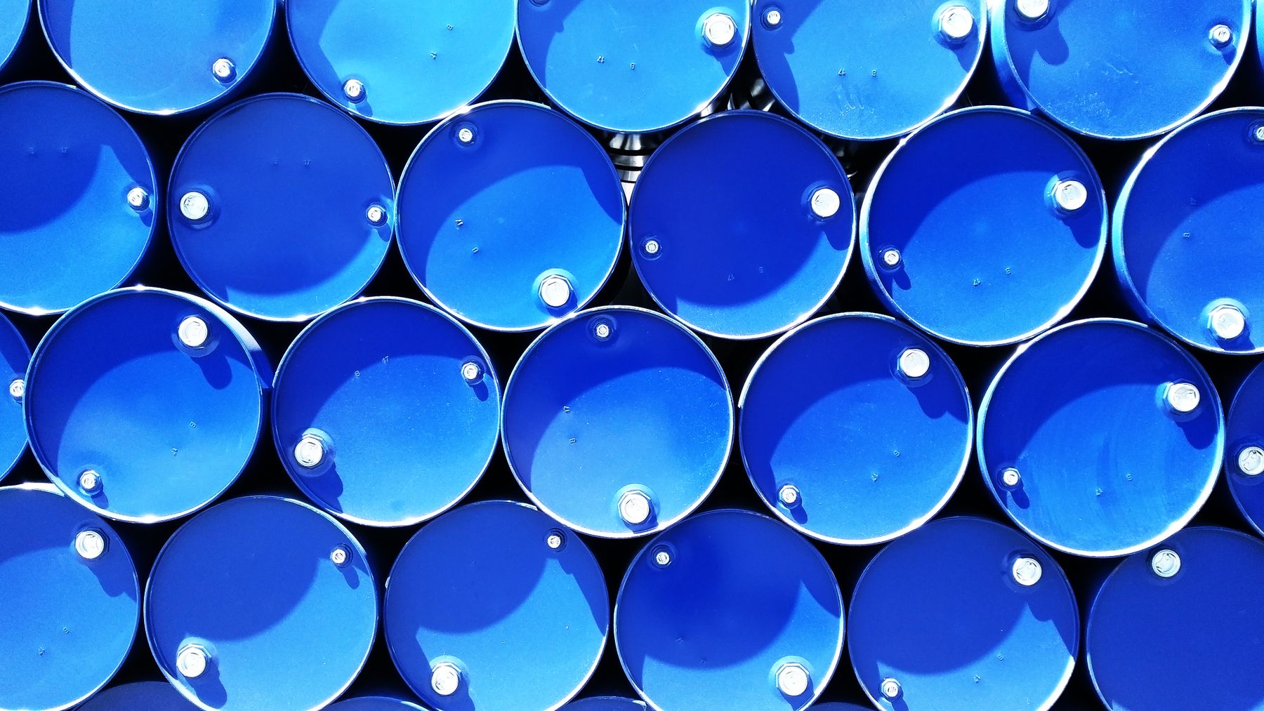 Overhead view of stacked steel chemical drums