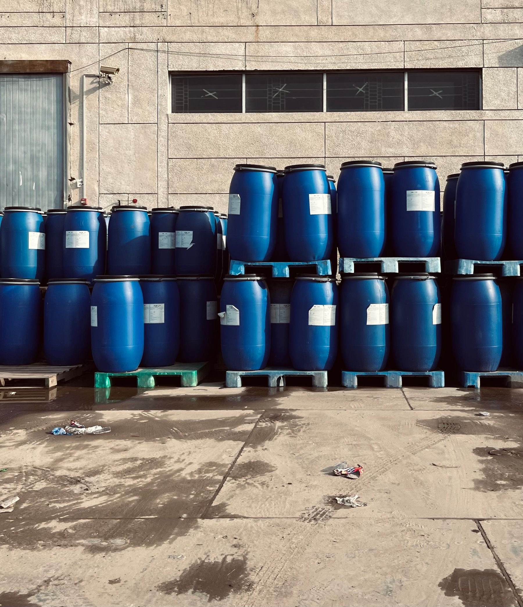 Stacked chemical drums with clamp lids and specification labels