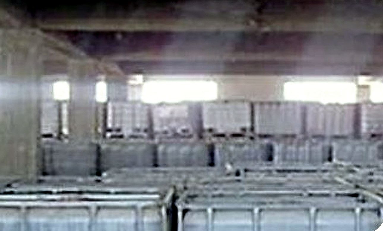 Rows of IBC totes stored inside the company's acid warehouse